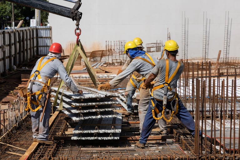 Construction workers welding steel beams