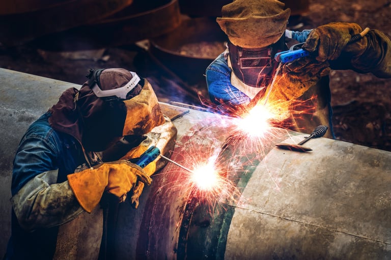 Workers on metal structure in factory