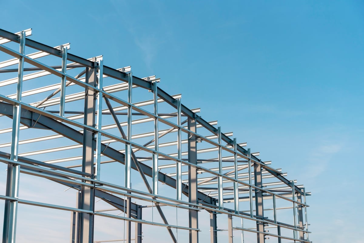 Industrial steel building construction with workers