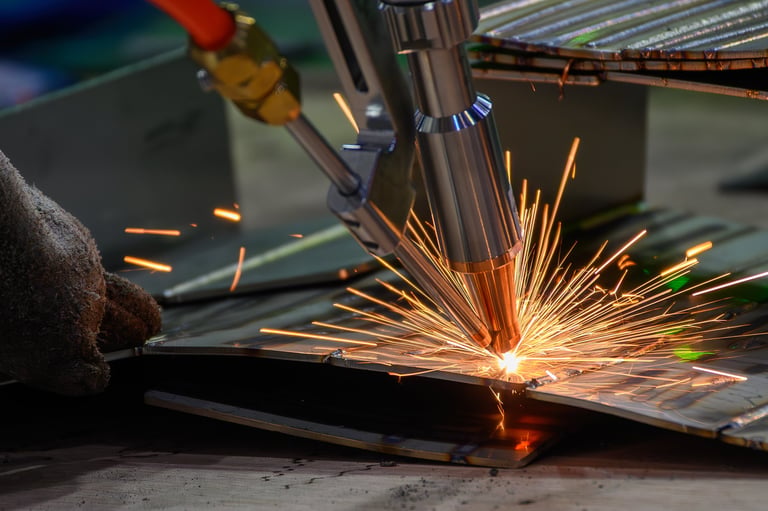 Professional metal worker welding with laser
